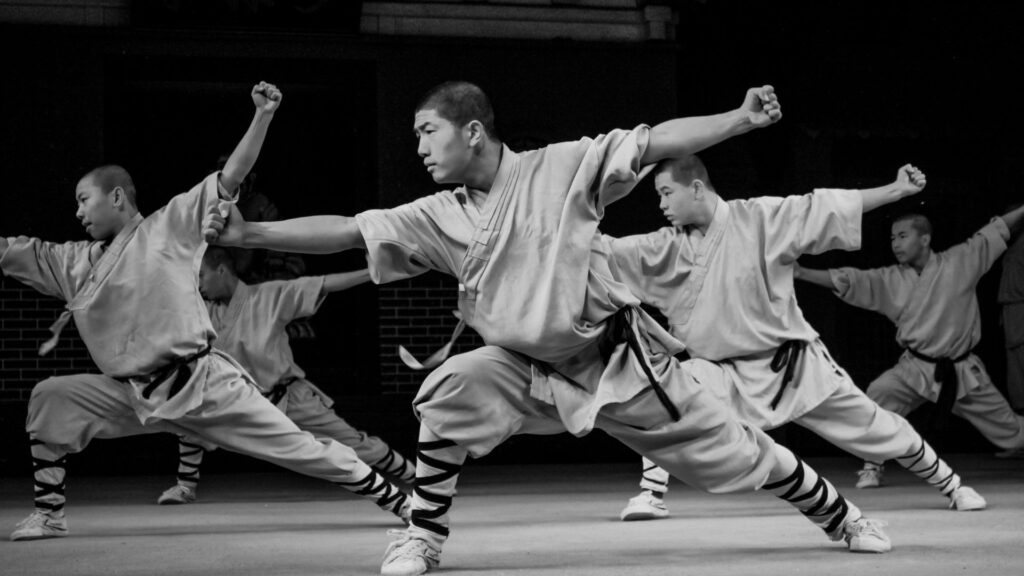 Shaolin Mönche führen Kampfposen aus - sie sind stark, ausdauernd und flexibel